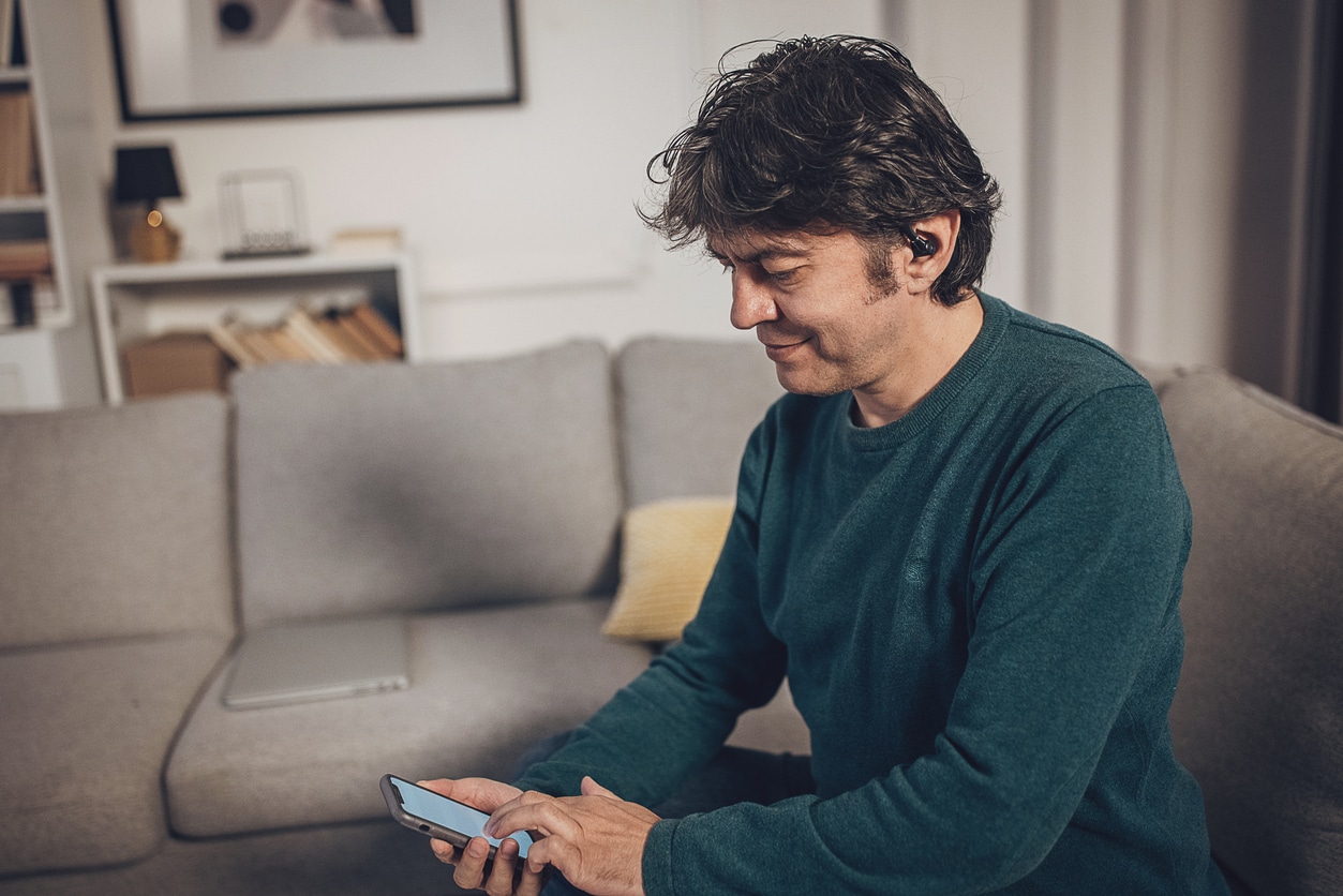 Man takes online hearing test on phone