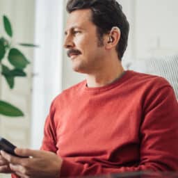 Man has hearing aid at home