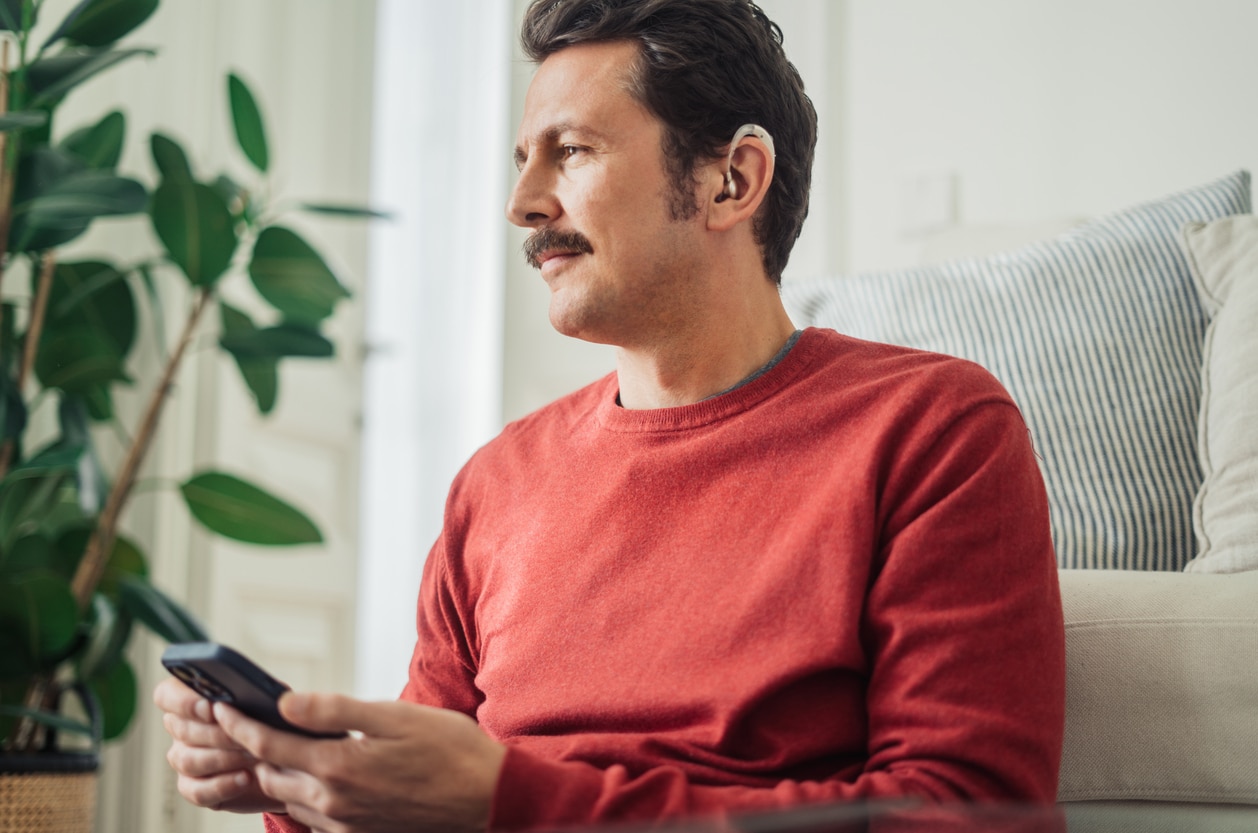 Man has hearing aid at home