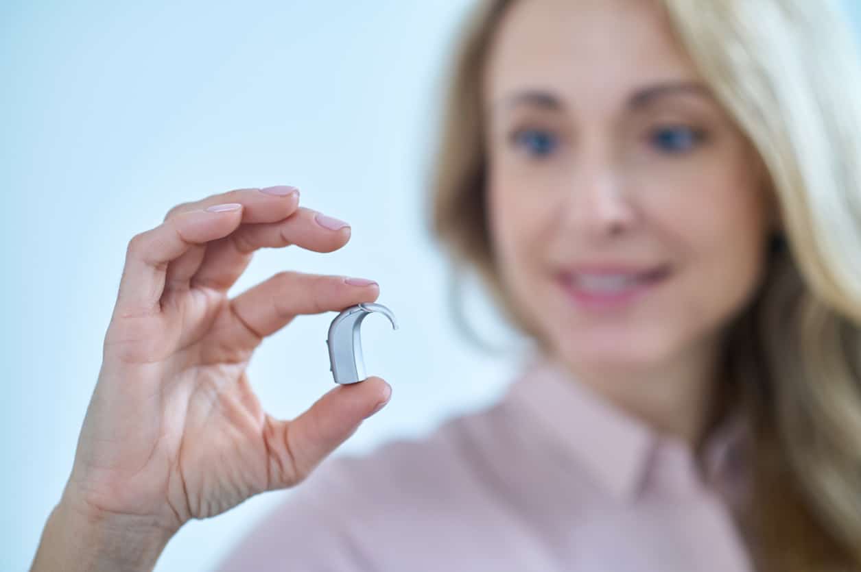 Woman showing off her new hearing aid