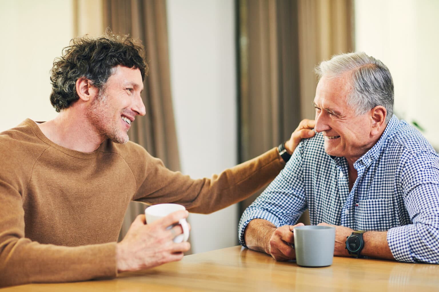 Father and his adult son having a heartfelt conversation.