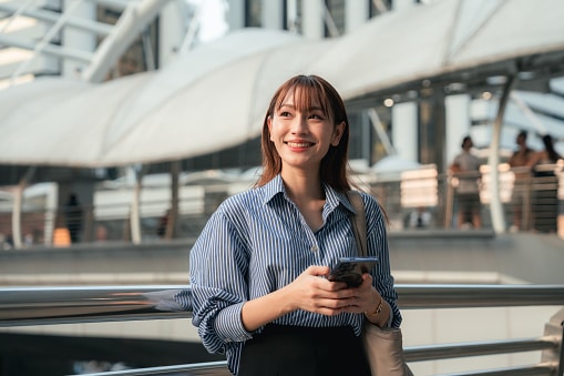 Confident woman on her phone in a trendy urban city.