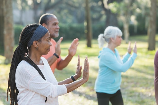 Outdoor tai chi class for seniors, improving balance and strength and building community.