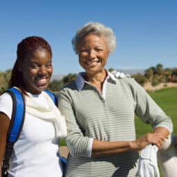 Grandmother and granddaughter going golfing together.