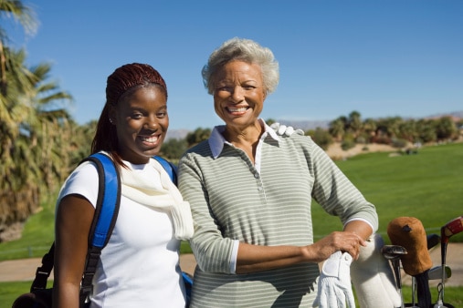 Grandmother and granddaughter going golfing together.